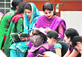 Students of BA-I make last-minute preparations before the exam at the University of Jammu on Friday. Tribune