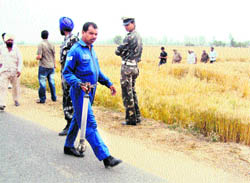 An Air Force personnel carries away the unexploded rocket fired from an IAF fighter