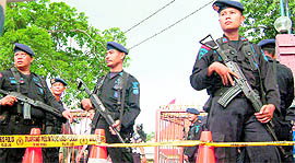 Indonesian mobile brigade policemen stand guard outside the mosque where a suspected suicide bomber blew himself up during Friday prayers in Cirebon.