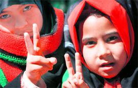 Libyan girls gesture during Frida prayers near the courthouse in Benghazi on Friday.