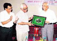 Former Chief Justice of the Punjab and Haryana High Court Mukul Mudgal is felicitated at a function at ICFAI University in Dehradun on Saturday