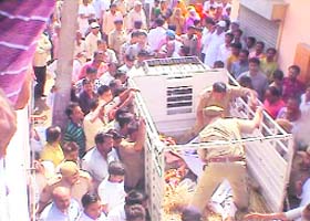 Policemen take the bodies of the victims for postmortem in Yamunanagar on Saturday