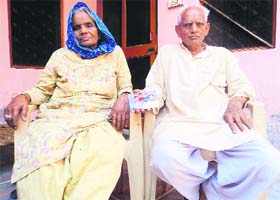 Kanishthas grandparents show a family photo at their residence in Kasni village in Jhajjar district on Saturday