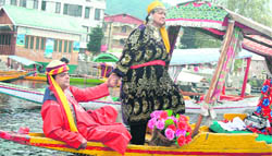 A tourist couple enjoys a shikara ride on the Dal Lake in Srinagar 