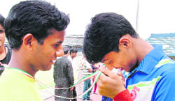 A visually impaired youth tries to read the inscription on the medal his friend was awarded at the concluding ceremony of the Seventh National Sports for Blind in Ludhiana on Saturday.