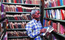 An attendant arranging books at the Public Library in Bathinda