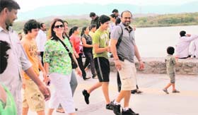 Chilling out: Visitors to Sukhna Lake enjoy stroll in a pleasant weather on Sunday