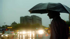 A pedestrian holds an umbrella to save himself from the rain at ITO.