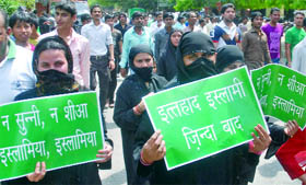 Muslim women protest against the killing of people in Bahrain, Libya and Yemen allegedly by US-led forces, at Parliament Street in New Delhi on Sunday.