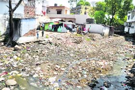 An open drain, full of filth in the Dobhalwala ward, near a residential area in Dehradun