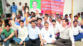 Ruling BJP workers stage a dharna to demand opening of the state rivers for picking and quarrying at Gandhi Park, Dehradun, on Sunday.