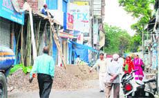 Roof extension work being carried out in the Main Bazaar of Hamirpur on Sunday.
