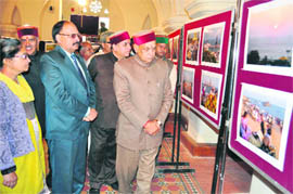 Chief Minister Prem Kumar Dhumal at a photo exhibition put up by Rajendra Rajan, an amateur photographer, at the Gaiety Theatre in Shimla on Sunday. The five-day exhibition organised in collaboration with the State Department of Language, Art and Culture has concluded