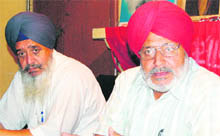 Balwinder Singh (right), secretary of the district council of the CPI, addresses a press conference in Amritsar on Sunday