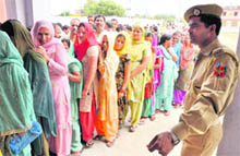 Women queue up to cast their vote during Phase II of the panchayat poll in Ranjari village of Samba district on Sunday.