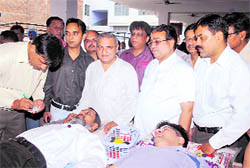 Senior Deputy Mayor Parveen Bansal (left) donates blood during a camp in Ludhiana