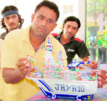 A fisherman shows the boat he made while he was lodged in a jail in Pakistan