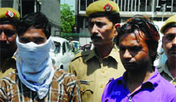 The two accused in police custody.
