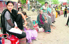 Consumers wait for LPG refills at Deep Nagar in Dehradun.