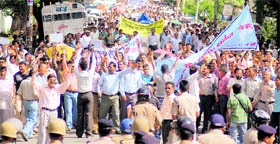 Activists of the Junior High School Shikshak Sangh hold a protest in support of their demands in Dehradun on Monday.