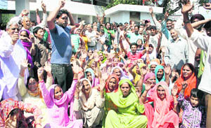 Villagers from RS Pura stage a demonstration against alleged bungling in the panchayat elections in Jammu on Monday. 