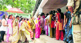 Siliguri residents queue up to cast their votes at a polling station on Monday.