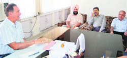 Faculty members of DAV College interact with RK Bedi, in charge of examination, Guru Nanak Dev University, regarding the paper in Amritsar