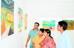 Atanu Chakraborty (left) displays his paintings at the Indian Academy of Fine Arts in Amritsar