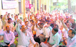 Roadways employees on dharna outside their office in Dehradun on Tuesday
