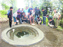 Tibetan students take a plaster of Paris impression of the pugmarks of a leopard that visited the campsite before their arrival during a study tour in Mussoorie. 