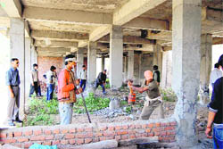 Workers of the Mussoorie-Dehradun Development Authority pull down an illegal structure on the way to the Bhatta Falls, near Mussoorie.