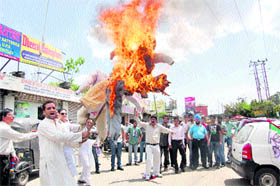 Activists of the Panthers Party burn an effigy of the BJP MLAs in protest against cross-voting in the Legislative Council elections, in Jammu on Tuesday.