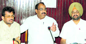 State BJP chief Ashwini Sharma (middle) along with Kamal Sharma (left) and Manjit Singh Rai at a meeting at Circuit House in Jalandhar on Monday.