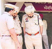 Police personnel outside the Axis Bank ATM in Amritsar on Tuesday.