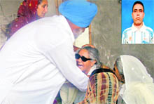 Baldev Singh consoles the mother of Baljit Singh (inset), who was shot in Philippines, at Kokri Heran village near Moga on Tuesday. 