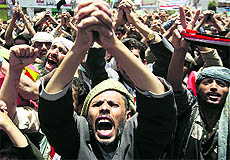 Anti-government protesters shout slogans during a rally to demand the ouster of Yemen's President Ali Abdullah Saleh outside Sanaa University on Monday.