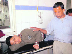 A boy who fell ill after having prasad undergoes treatment at Doon Hospital in Dehradun on Wednesday