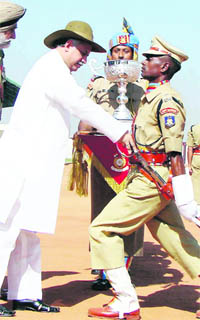Union Minister of State for Home Affairs Gurudas Kamat honours a young officer during the passing-out parade of Assistant Commandants at the CRPF Academy in Kadarpur, Gurgaon, on Wednesday.
