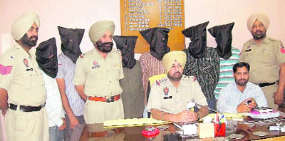 Police officials produce the kidnappers before the mediapersons at a press conference in Phagwara on Wednesday.