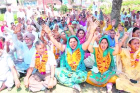 Members of the PoJK Refugee Front stage a protest in Jammu on Wednesday