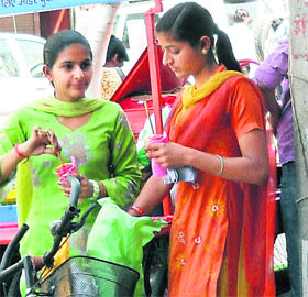 These girls enjoy ice lollies on a hot afternoon at Sadar Bazaar in Ambala Cantonment.