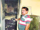 Lab in charge Balwinder Singh shows the burnt medicines and lab apparatus at the Primary Health Centre, Arjanwal village, near Adampur, in Jalandhar