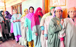 Women queue up outside a polling station to cast their votes during the panchayat elections in Ganderbal on Thursday