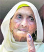 Nirmala Devi (88) shows ink mark on her finger after casting vote