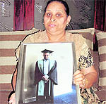 Parveen Kanta holds the picture of her son, Nitin Garg, who was stabbed to death while walking through a park in Melbourne.