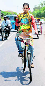 An environmental activist pedals around Chandigarh to spread the message of Save Earth on Friday.