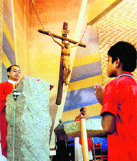 Devotees attend a Good Friday prayer at a Church in Sector 19, Chandigarh, on Friday.