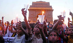 Children from Bachpan Bachao Andolan participate in a candlelight march to pay homage to Moin at India Gate in New Delhi on Friday.