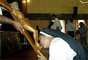 A nun kisses the feet of Jesus Christ at Sacred Heart cathedral in New Delhi on Good Friday.