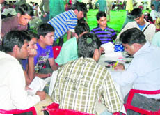 Candidates register themselves at a job fair in Dharamsala on Friday.